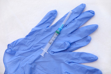 Medical gloves and syringe