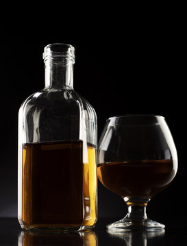 cognac glass and bottle dark studio shot