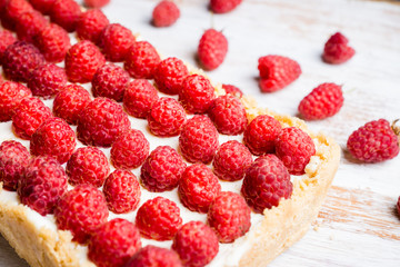Fresh raspberry cheesecake on the rustic background. Selective focus. Shallow depth of field.