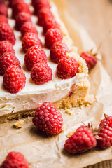 Fresh raspberry cheesecake on the rustic background. Selective focus. Shallow depth of field.
