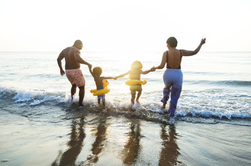 Black family having fun on the beach