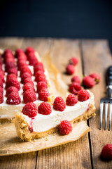 Fresh raspberry cheesecake on the rustic background. Selective focus. Shallow depth of field.