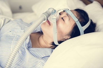 A woman wearing anti-snoring chin straps