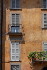 Window shutters with flowers in Bergamo, Italy