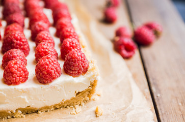 Fresh raspberry cheesecake on the rustic background. Selective focus. Shallow depth of field.