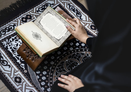 Muslim woman reading from the quran