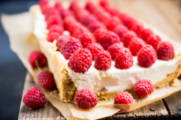 Fresh raspberry cheesecake on the rustic background. Selective focus. Shallow depth of field.