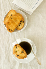 Morning coffee with biscotti, lump sugar and fresh newspaper. Rustic style.