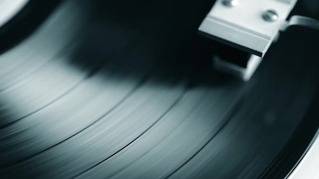 vintage turntable playing vynil closeup footage, view from above, sliding camera movement