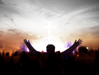 Church worship concept:Christians raising their hands in praise and worship at a night music concert - obrazy, fototapety, plakaty