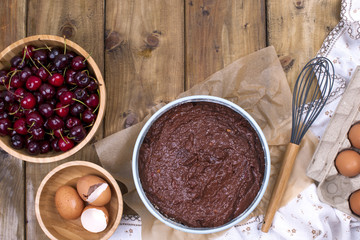 Preparation of a chocolate cake with a cherry. Traditional American cake. Ingredients for baking. banner. Flat lay,