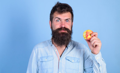 I love apples! Man handsome hipster with long beard eating apple. Hipster hungry bites enjoy ripe apple. Man diet nutrition eats fruit. Healthy nutrition concept. Fruit healthy snack always good idea