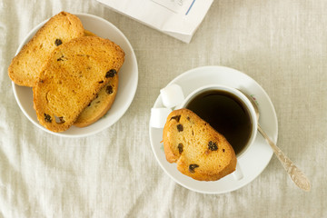 Morning coffee with biscotti, lump sugar and fresh newspaper. Rustic style.
