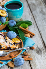 Plum pie with cinamon and almonds background