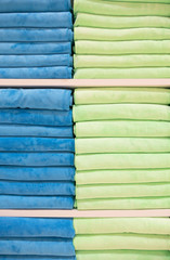 many colorful towels is folding in shelfs at store for Sales . 