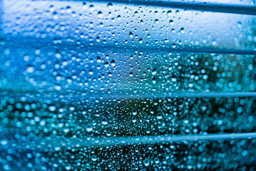 Naklejka na ściany i meble Water drops on glass. Rain drops on clear window