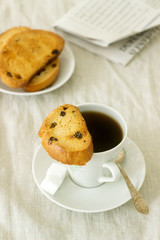 Morning coffee with biscotti, lump sugar and fresh newspaper. Rustic style.