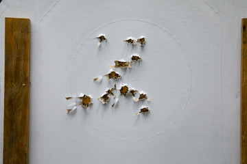 Paper shooting target with bullet holes