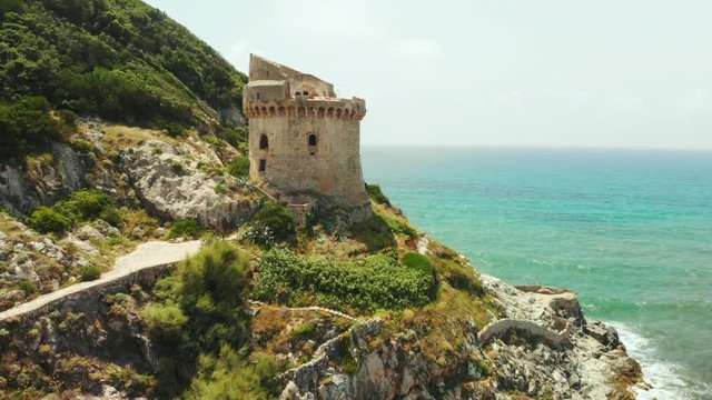 Tower of Paola. It's construction of the Middle Ages times. Sabaudia, Lazio, Italy. Riviera di Ulysses. Aerial drone view to big mountain and turquoise sea water