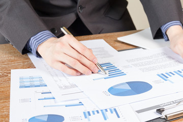 business man analyzing graph and chart document report
