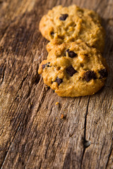 Chocolate chip cookies on rustic wood background.  Sweet biscuits. Homemade pastry