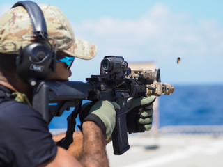 Man shooting rifle,shell ejecting