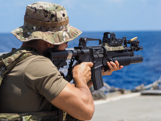 Man shooting rifle,shell ejecting