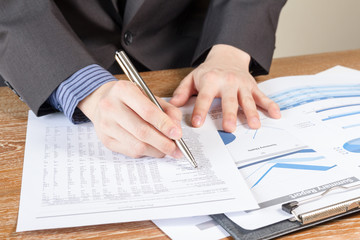 business man analyzing graph and chart document report