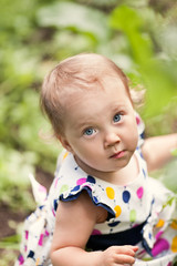 Portrait of cute little girl in summer garden