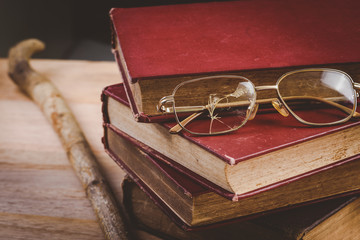 old generation  of information ignored concept, close-up of broken old glasses on wooden table, vintage tone