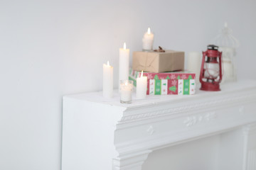 blurred image. candles and gift boxes on the fireplace in the living room .photo with copy space