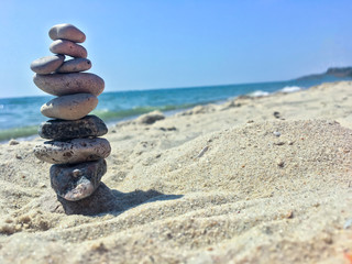 Fototapeta na wymiar A group of sea stones on the sand near sea.