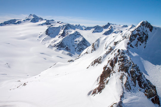 Winter snow covered mountain peaks Austrian alps © Kotangens