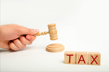Tax law concept with a gavel. tax court judgments. judge's hand and the inscription 