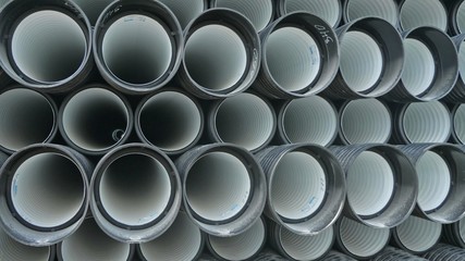 Warehouse of finished plastic pipes industrial outdoors storage site. Manufacture of plastic water...