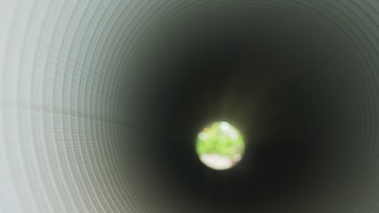 Warehouse of finished plastic pipes industrial outdoors storage site. Manufacture of plastic water pipes factory. Process of making plastic tubes on the machine tool with the use of water and air