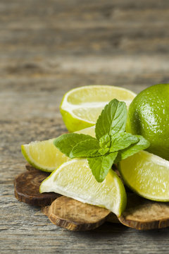 Fresh citrus lime mint berries on wooden background. Copy space for text.