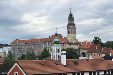 Cesky Krumlov castle and ancient historical houses and sky with stormy clouds, Czech Republic..