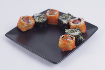 set of Sushi rolls on black plate