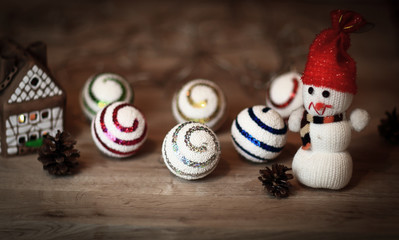 Christmas balls and a toy snowman on Christmas table