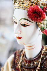 Traditional Thai puppet doll with elegant costume and head ornament
