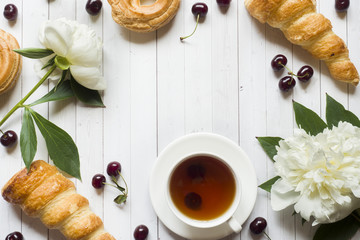 Frame custard cakes cherry flowers peony tea Cup. Copy space