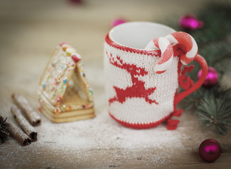 Christmas Cup ornament and sweets on wooden background.