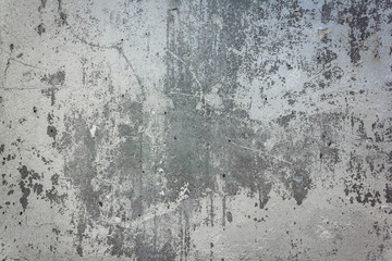 Gray concrete wall with peeling paint. Texture and background