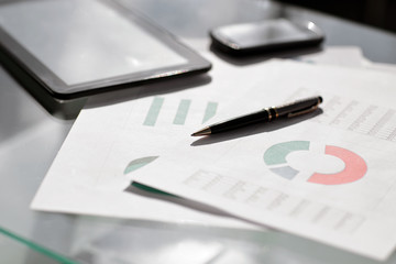 Financial paper charts and graphs on the table