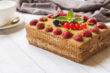 Honey cake with strawberries, mint and currants.