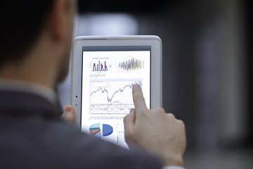 portrait of handsome businessman on blurred office background