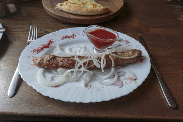 Kebab with ketchup and onion. Middle Eastern food.