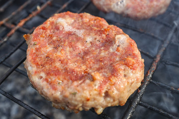 Fresh meat patties for burgers on the grill