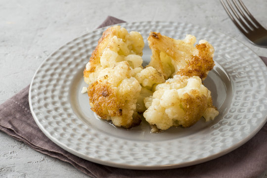 Florets of cauliflower batter fried in oil on the plate
